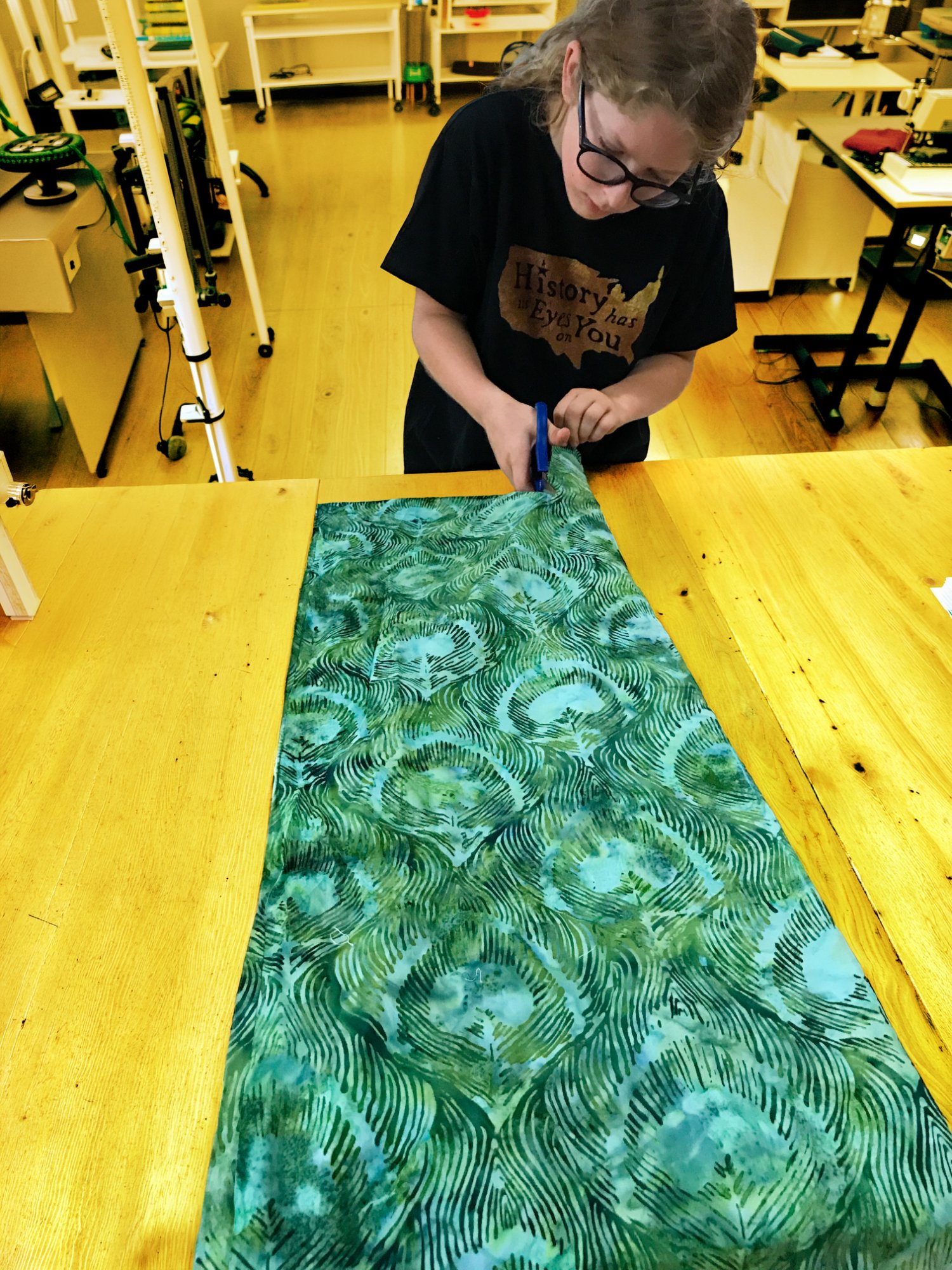 Student cutting fabric