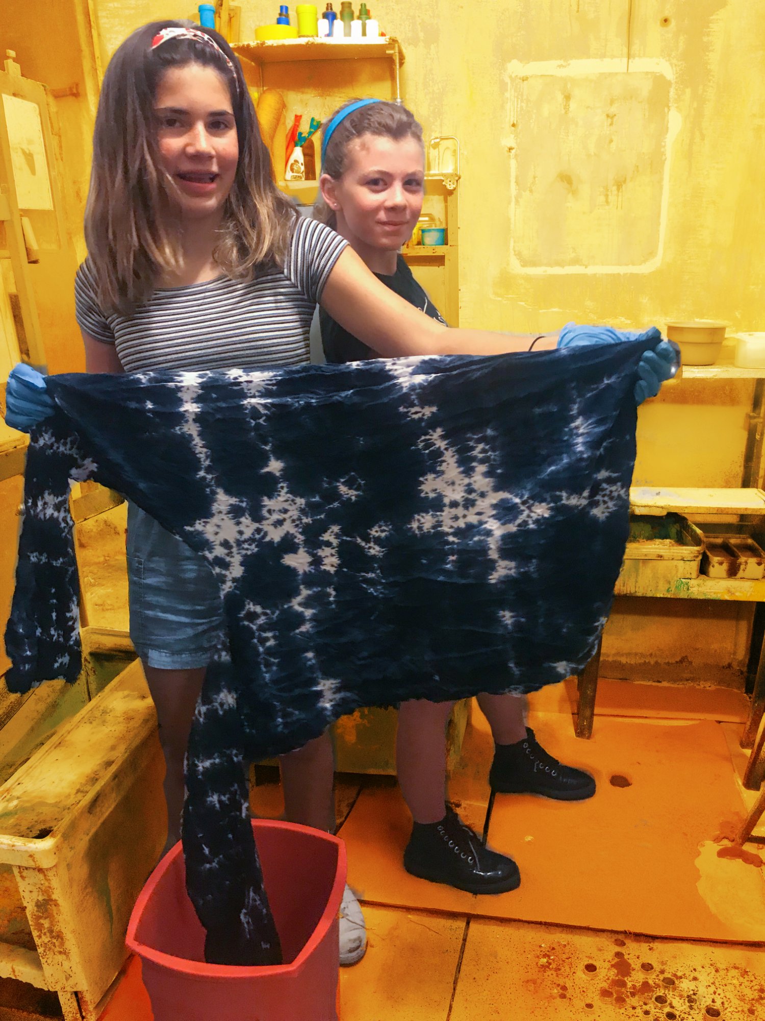 Students with indigo-dyed fabric